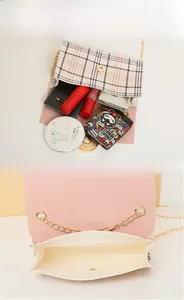 Detail view of plaid crossbody bag showing storage capacity for phone and makeup