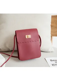 Close-up of wine red lace-edged phone bag with gold square buckle and litchi texture