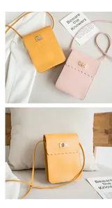 Detail of elegant ladies mini phone bag featuring scalloped edge and golden metal lock