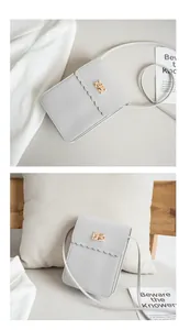 Detailed view of light gray PU leather phone bag with scalloped edges and gold swivel lock
