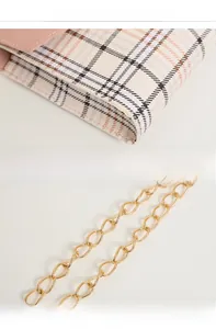 Detail of high-quality gold metal chain and fine stitching on a plaid crossbody bag