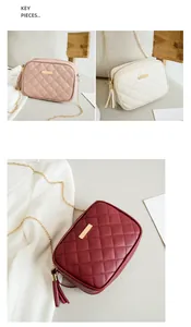 Detail view of quilted cross-body bags with chain straps and decorative tassels in multiple colors