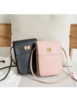 Vertical mini shoulder bags with scalloped edges and gold buckles in black and pink