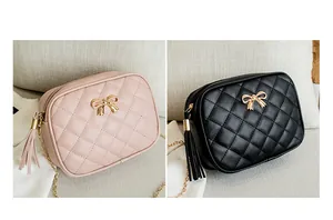 Close-up of pink and black quilted camera bags with bow hardware and tassel details