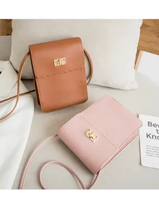 Detail view of small faux leather phone bags with lace trim and gold twist locks