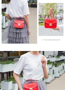 Detailed view of women's red crossbody bag with gold chain strap and metal lock closure