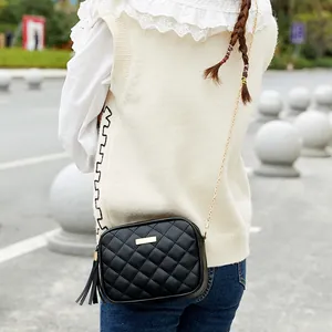 Women's black quilted crossbody bag with gold chain and stylish leather tassel