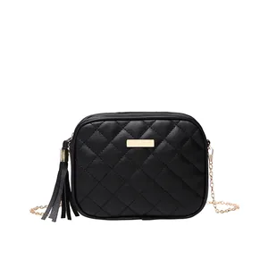 Black quilted crossbody bag with gold chain strap and stylish leather tassel detail