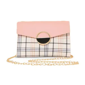 Pink patchwork plaid crossbody bag with gold chain strap and metal ring closure