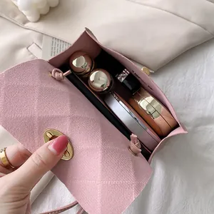 Pink quilted suede small crossbody bag with metal lock showing daily interior storage