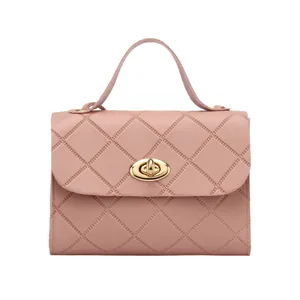 Elegant pink quilted handbag with gold oval twist lock and a single top handle strap