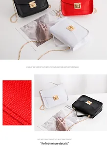 Detailed view of the textured synthetic leather and elegant gold metal lock on a small bag