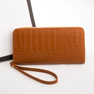 Cartera de piel sintética marrón con grabado de cocodrilo y correa de mano
