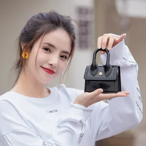 Mini black PVC jelly handbag with V-shaped stitching and golden snap button for women