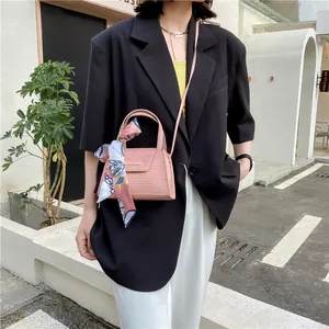 Pink crocodile pattern handbag with decorative silk scarf and top handle for women
