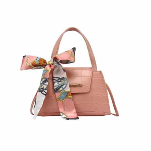 Pink croc-embossed small square handbag with decorative floral silk scarf and gold logo