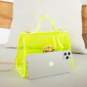 Neon yellow transparent PVC crossbody bag with gold chain strap and metal lock closure