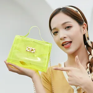 Neon yellow transparent PVC crossbody bag with gold chain strap and metal lock closure