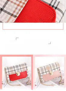 Detail of plaid patterned crossbody bag featuring heart motif and gold chain strap