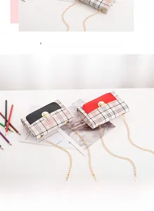 Top view of mini plaid crossbody bags with gold chain straps and twist-lock details