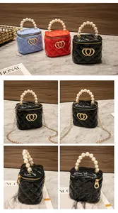 Dettaglio della mini borsa a secchiello jelly con manico di perle e ciondolo a cuore