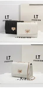 Detail of V-quilted faux leather crossbody bag with golden chain and twist lock