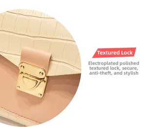 Close-up of golden electroplated metal clasp on beige crocodile pattern leather bag