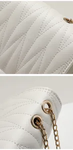 Detail of leaf-vein quilted cream leather bag with light gold metal chain strap eyelets