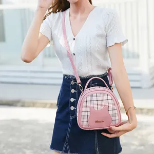 Women's plaid crossbody bag featuring a pink cat motif and adjustable shoulder strap