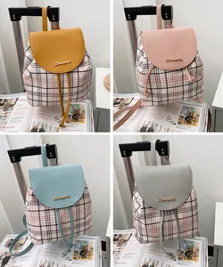 Vista detallada de mini mochilas de cuadros en amarillo, rosa, azul y gris con solapa