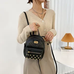 Women's black mini PU leather backpack with gold rivets and front zipper pocket