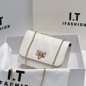 White quilted chain crossbody bag with gold lock buckle and matching gift packaging