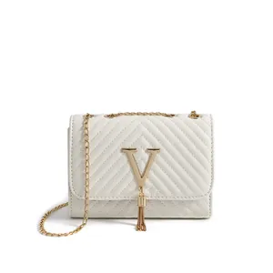 White quilted flap crossbody bag with golden V-logo tassel and metal chain strap