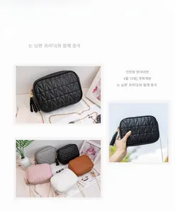 Close-up of quilted leather crossbody bags with gold chain straps and tassel details