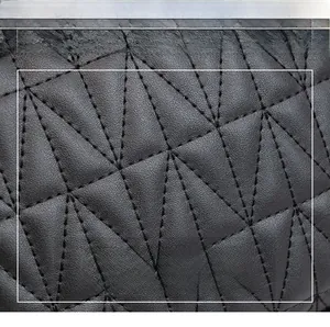 Macro detail of high-quality dark grey faux leather with geometric triangle quilting design