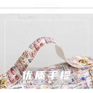 Close-up of colorful abstract printed fabric and golden metal buckle on the chain small bag