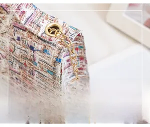 Macro shot of colorful tweed fabric texture and golden metal chain strap on a small bag