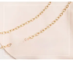 Close-up of a polished gold-plated metal chain strap with elegant oval links