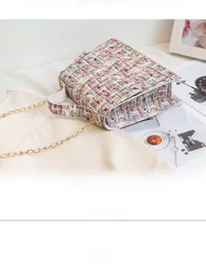 Close-up of a multi-color tweed crossbody bag with gold chain and white handle details