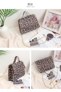 Detail of small crossbody bag featuring black multi abstract print and gold chain strap