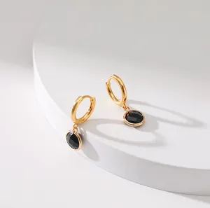 Detailed close-up of French vintage gold hoop earrings with black zircon pendant