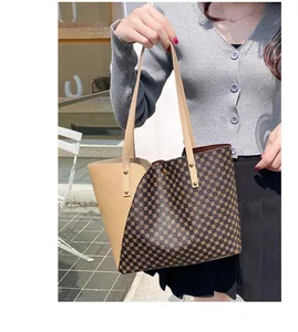 Detailed view of bicolor tote bag with khaki leather and geometric dot patterns