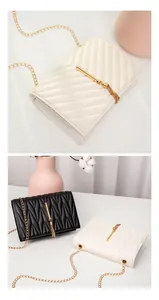 Detail showing V-quilted small square bag with golden chain and tassel in cream and black