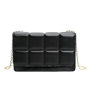Modern black quilted square crossbody bag with luxury gold chain strap and padded finish