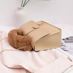 Elegant beige crossbody bag with plush brown handle and gold chain strap for autumn style