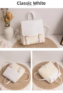 Detail view of monogram white mini backpack showing gold buckles and textured geometric pattern
