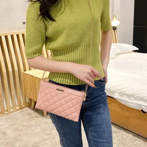 Pink quilted chain crossbody bag for women with golden metal detail and slim shoulder strap