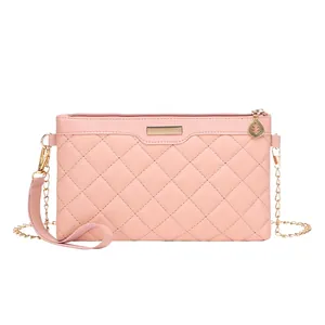 Pink quilted crossbody bag with gold chain strap and leaf pendant for women