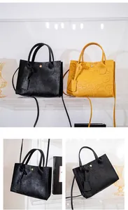 Detailed pattern embossing on black and yellow leather handbags with gold metal buckle