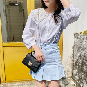 Chic black quilted chain small crossbody bag for women paired with a stylish casual outfit